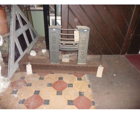 A small 19th century cast iron firegrate with raised relief foliate panels and bow fronted basket together with a fender with