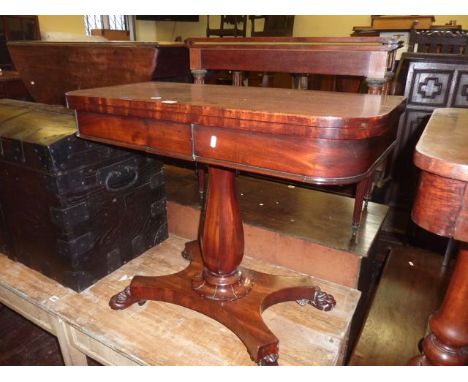 A Regency mahogany D-end fold over top card table raised on an octagonal vase shaped pillar and platform base with lions paw 