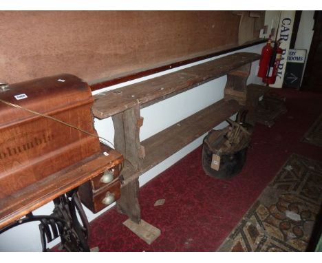 A low vintage pitch pine refectory bench with plank seat and through jointed supports together with one other slightly smalle