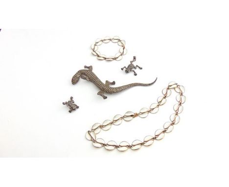 A Norwegian silver gilt and enamelled necklace and bracelet, composed of white enamelled leaf links; a marcasite lizard brooc