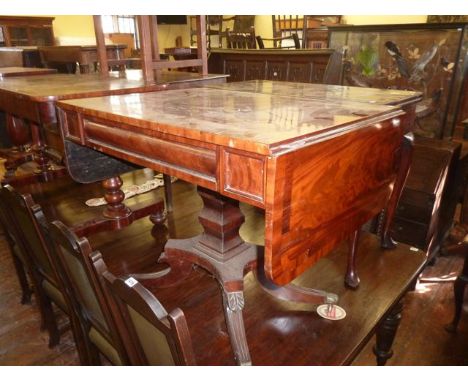 A Regency mahogany sofa table of rectangular form with two drop leaves and frieze drawer, raised on a square cut column, plat