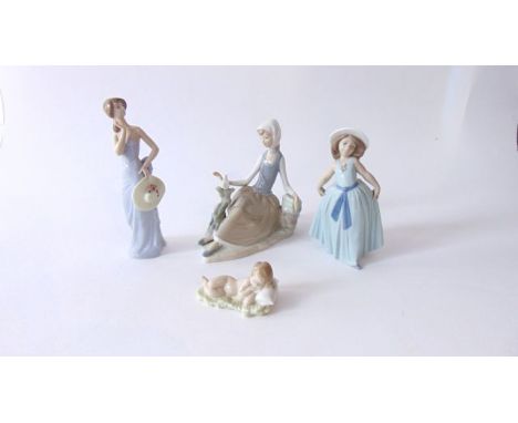 A collection of Lladro figure groups comprising a seated girl with a dove, a stylish young woman holding a wide brimmed hat, 