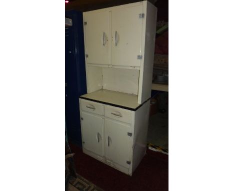 A vintage aluminium freestanding kitchen cabinet with cream painted finish, the upper section enclosed by two doors over an o