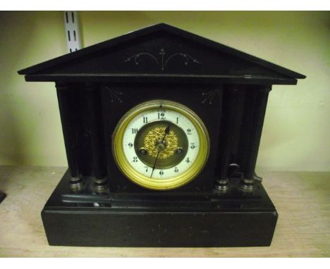 A Victorian black slate mantel clock in the classical style with column supports and 8-day striking movement