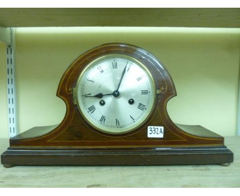 An inlaid Edwardian mantel clock with striking movement