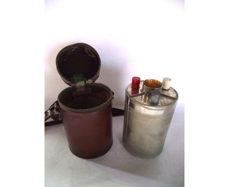 A trio of curved silver plated flasks centred by four associated liquor cups, stamped to underside Made in Germany, set withi
