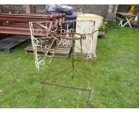 An iron work planter of rectangular form with single canted side and decorative scrollwork detail together with one other 