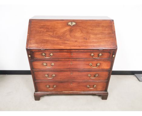 Georgian bureau,  with fitted interior, drop front over four graduated drawers having brass Swan neck handles, set on bracket