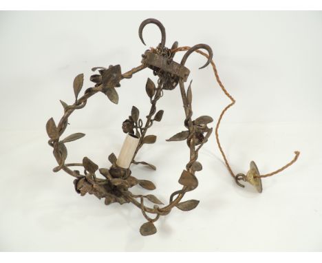 A hanging metal light with gilt effect, with central candle style light fixture and hanging basket design with trailing vines