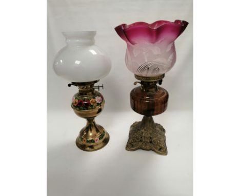 A 20th Century barge ware brass oil lamp with hand painted floral decoration in the folk art tradition,  height 29cm, togethe