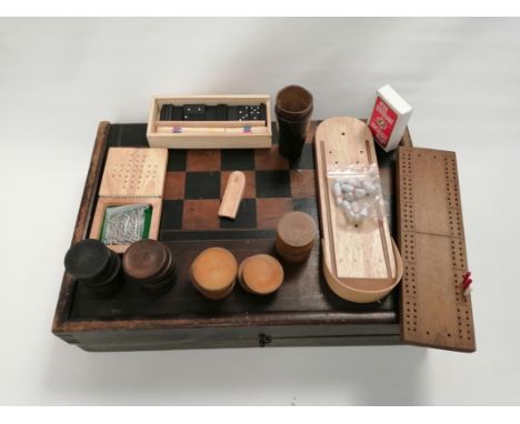 A boxed gaming set with chess board exterior opening to reveal a quantity of associated items,  to include leather dice tumbl