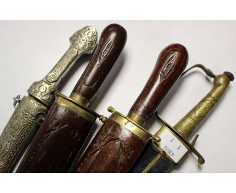 Four Middle Eastern daggers:

One with white metal grip inscribed "Souvenir de Syria"

Two with wooden grips and scabbards.

