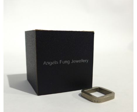 ANGELA FUNG (Contemporary Jewellery artist) A square form ring, possibly Titanium, set with three small diamonds. Size K/L