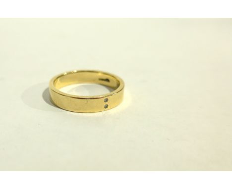 AMANDA DOUGHTY (Contemporary Jewellery artist) A 9ct gold ring set with two small diamonds. Size P/Q