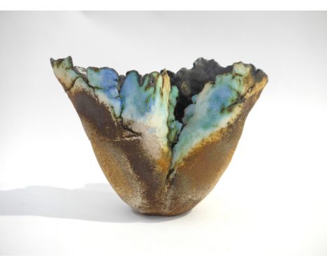 A studio pottery vase, hand built in the style of Ewen Henderson with flashes of blue glaze. Unmarked. 14cm high. (chips to r