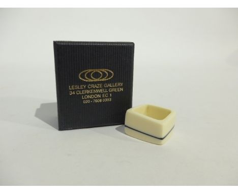 A Kaz Robertson for Lesley Craze Gallery contemporary ring in white resin with single black line detail, size I/J. Boxed.