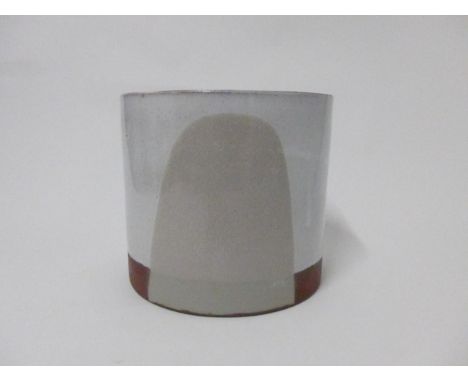 SILVIA K (XX/XXI) A studio pottery cylindrical vase in terracotta with grey and buff coloured slips. 16cm high x 18cm diamete
