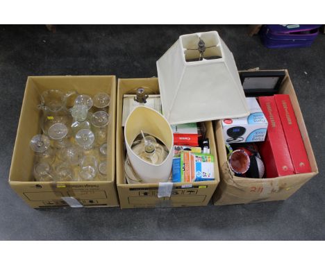 Three boxes of glassware, lamps, ink jet cartridges, alarm clock, headphones etc 