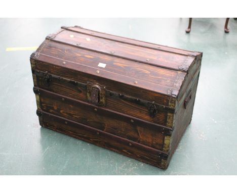 Dome topped wooden trunk opening to blue &amp; gold striped interior 