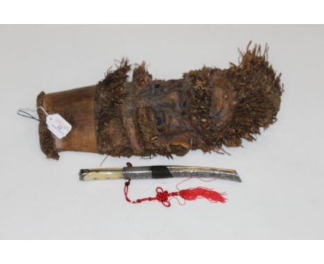 Carved wooden mask of bearded man and a horn handled dagger  