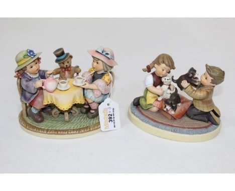 Two Hummel figural ornaments, "Puppy Surprise" and "Tea Time"