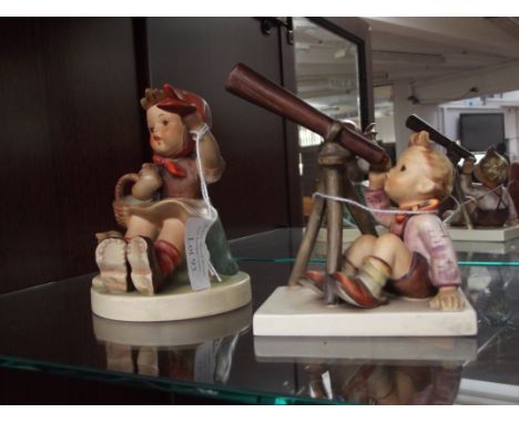 Hummel figure of a boy with telescope together with a larger example 