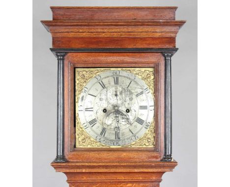 A mid-18th century oak longcase clock with eight day movement striking on a bell, the 12-inch square brass dial with silvered