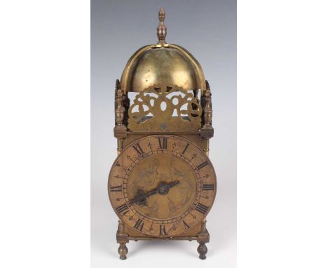 An early 20th century brass lantern clock style mantel timepiece, the chapter ring with Roman hour numerals, the case with be
