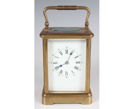 A late 19th/early 20th century brass corniche cased carriage timepiece with eight day movement, the white enamelled dial with
