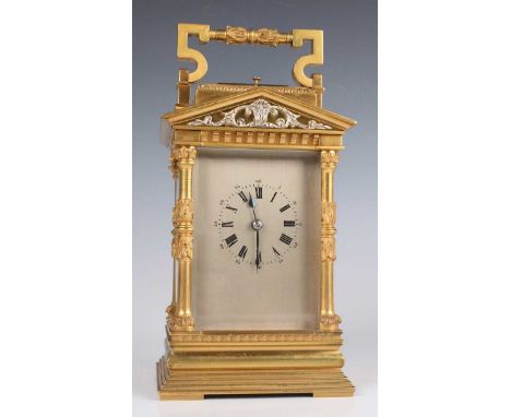 An early 20th century French lacquered brass carriage clock with eight day movement striking hours and half hours on a gong, 