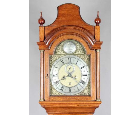 A mid-18th century oak longcase clock with eight day movement striking on a bell, the 12-inch brass breakarch dial with silve