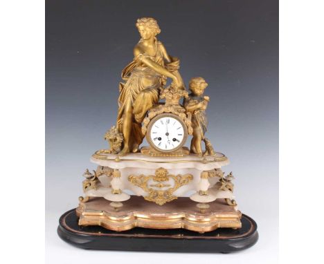 A late 19th century French gilt spelter and alabaster mantel clock with eight day movement striking on a bell, the circular e