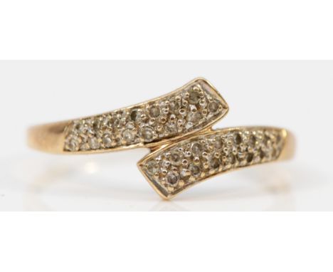 A 9ct gold diamond bypass ring, U, 2g 