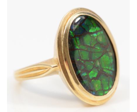 Korite, a North American 10K gold and ammolite single stone ring, signed, stone 17 x 12mm, 6.1gm. Ammolite is an opal-like or