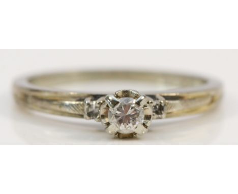 An 18K white gold and brilliant cut diamond single stone ring, diamond set shoulders, estimated 0.10cts, colour G/H, clarity 