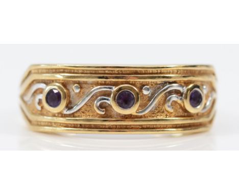 A 9ct gold amethyst patterned ring, U, 3.2g Minor surface scratches typical for its age, small chip to the tableau of the cen