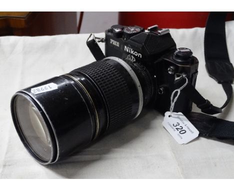 A Nikon FM2 camera with lens.