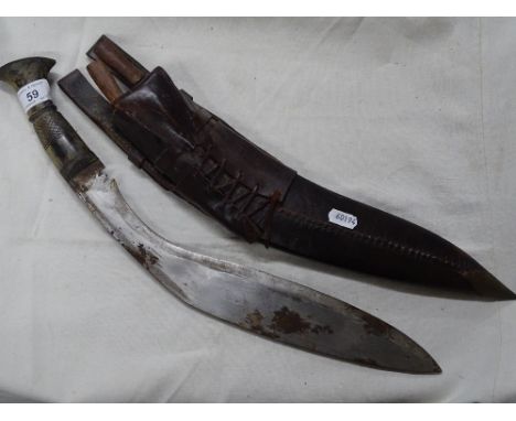 A Kukri knife with horn handle and leather scabbard.