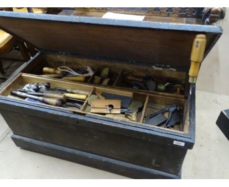 A pine ships chest with fitted interior full of carpenter's tools.
