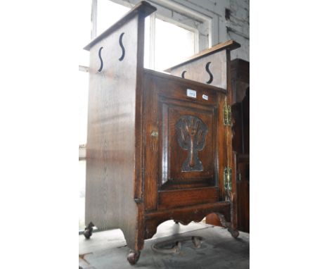 An oak Arts & Crafts stool, with stylised carved panelled door, width 38cm, height 65cm.