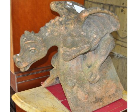 A weathered terracotta ridge tile in the form of a gargoyle, width 50cm, height 45cm.