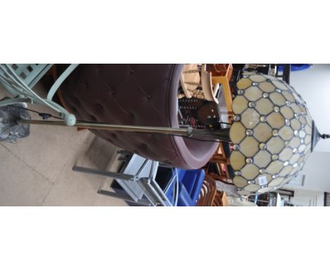 A brass effect metal standard lamp with Tiffany style shade.