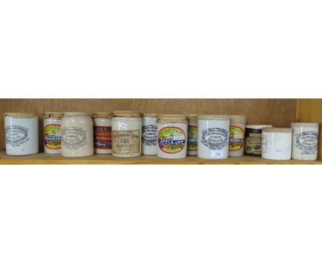 A shelf of Stoneware marmalade and jam jars.