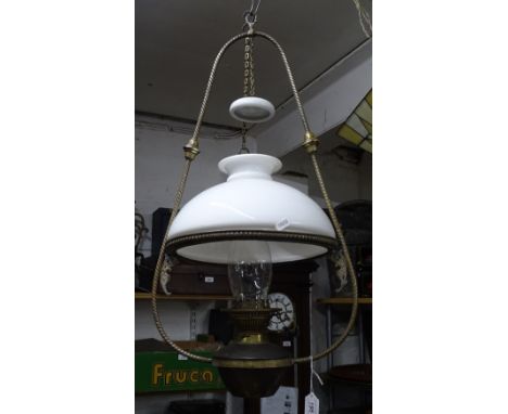 A large Victorian brass framed hanging oil lamp complete with shade and chimney.