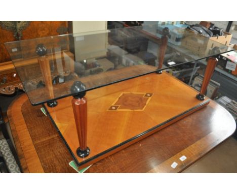 A coffee table in post modern Biedermeier style, having rectangular glass top over fluted tapered cherrywood columns ebonised