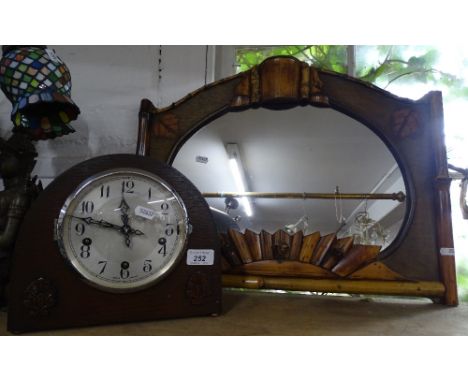 A mantel clock with 3-train movement and a carved wood framed mirror.