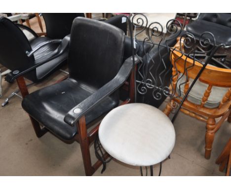 A 1990s post modern wrought-iron chair and a Danish Dyrlund mid century black leather and Bolivian Santos armchair.
