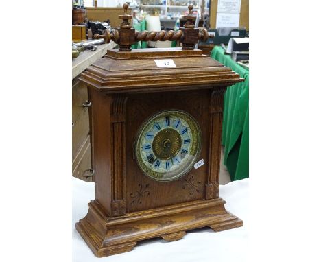 An oak cased mantel clock with painted dial.