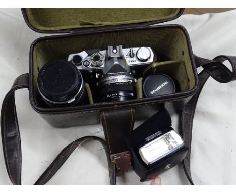An Olympus camera with lenses, etc., cased.