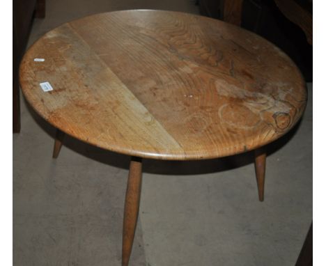 An Ercol circular coffee table, turned legs, width 73cm, height 41cm.